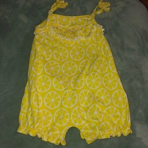Set of two onesies in yellow for girls.